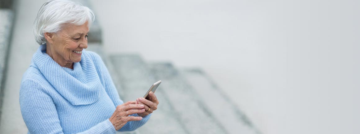 Elderly couple using mobile phone