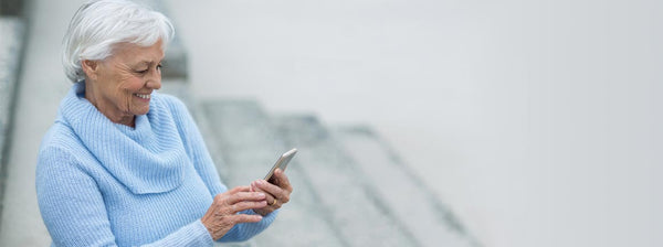 Elderly couple using mobile phone