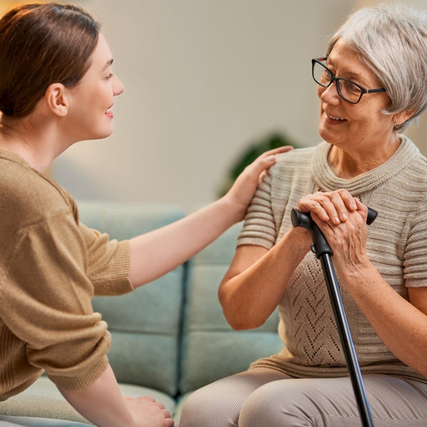 Happy elderly holding hands with relative