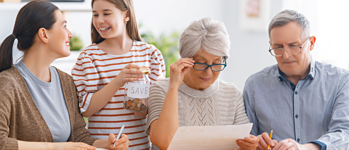 Happy family helping elderly manage budget