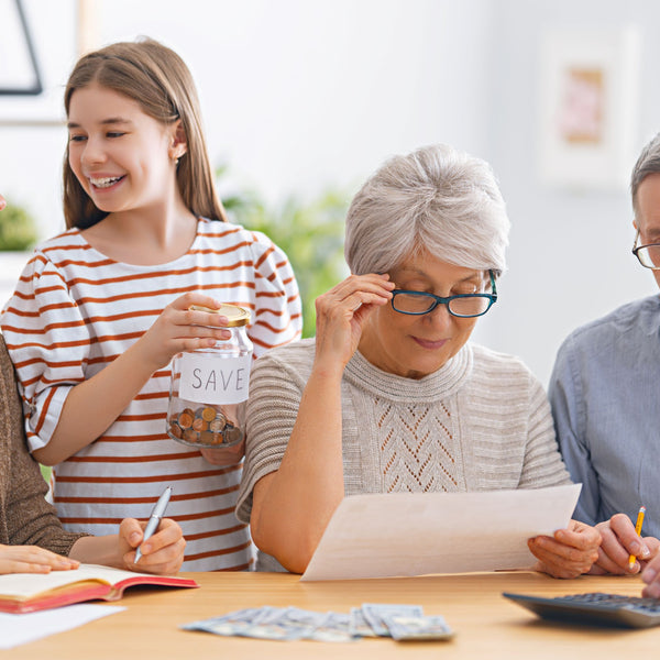 Happy family helping elderly manage budget