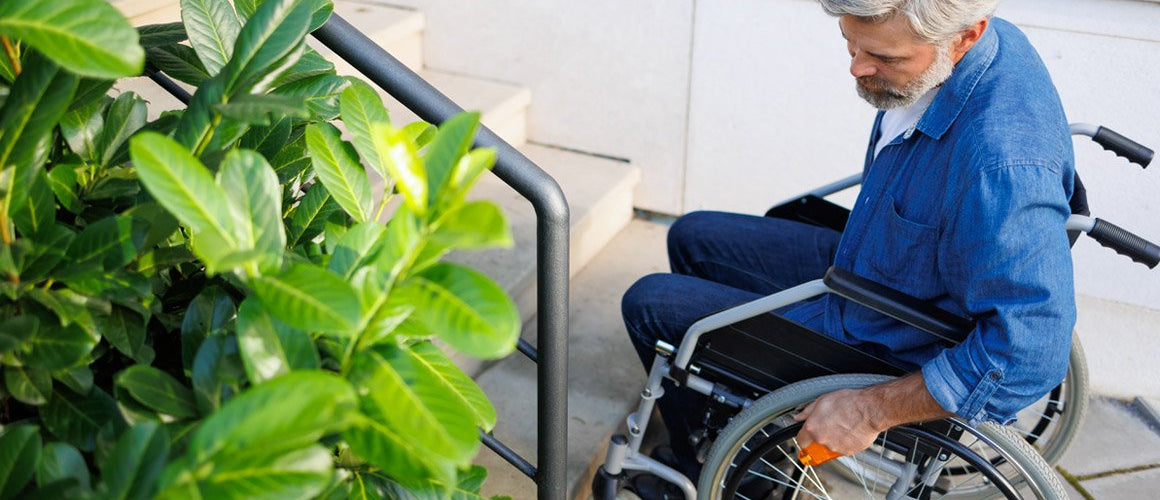 Disabled man by outdoor steps