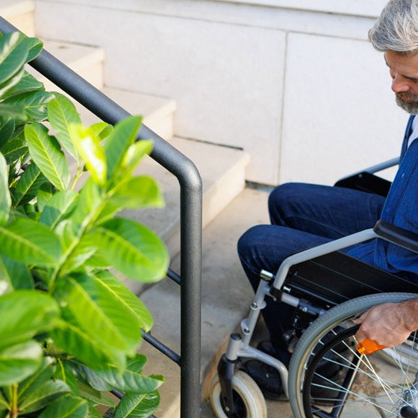 Disabled man by outdoor steps