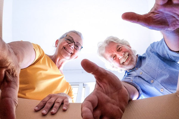 Elderly couple with removal box