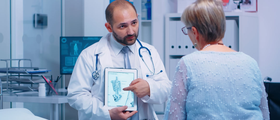 GP giving advice on Osteoporosis to an elderly woman