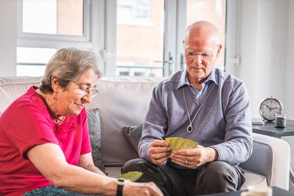 Elderly couple playing cards