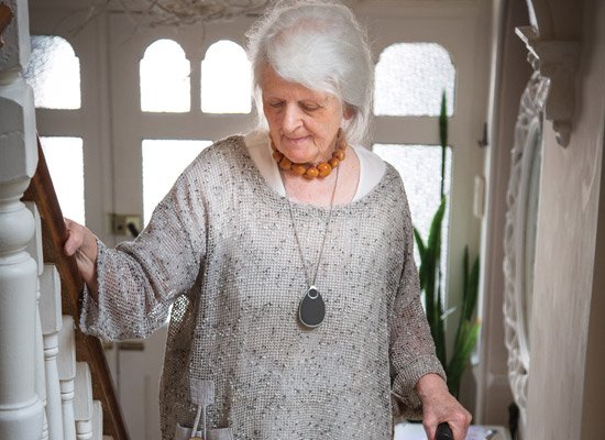 Lady wearing panic alarm with fall detection