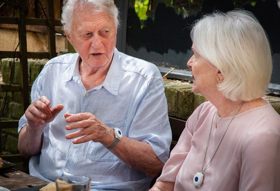 Elderly couple wearing digital fall alarms
