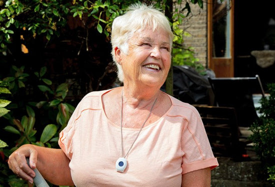Elderly person wearing digital fall alarm