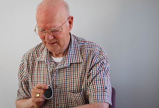 Older man pressing Taking Care GO button