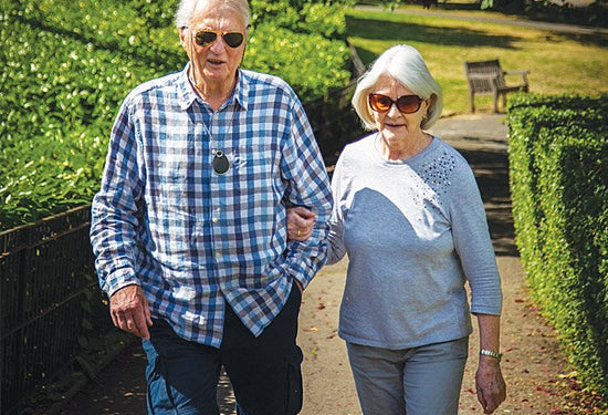 Elderly couple with man wearing Taking Care Anywhere