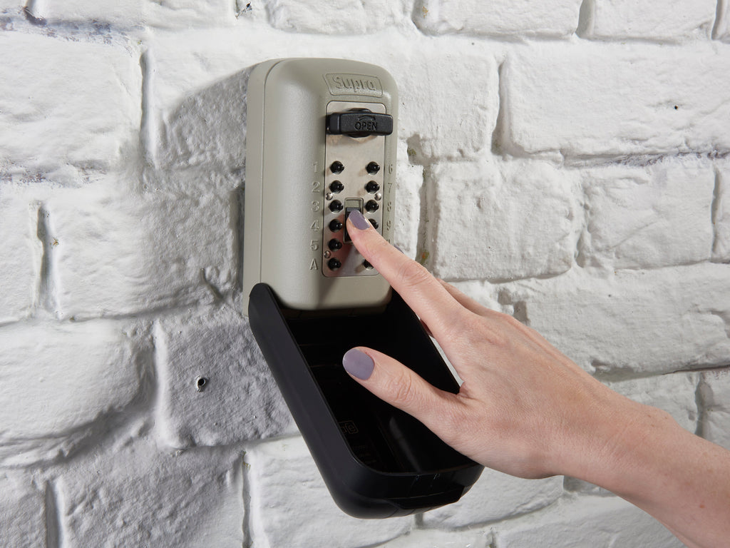 Person putting their key in key safe safely