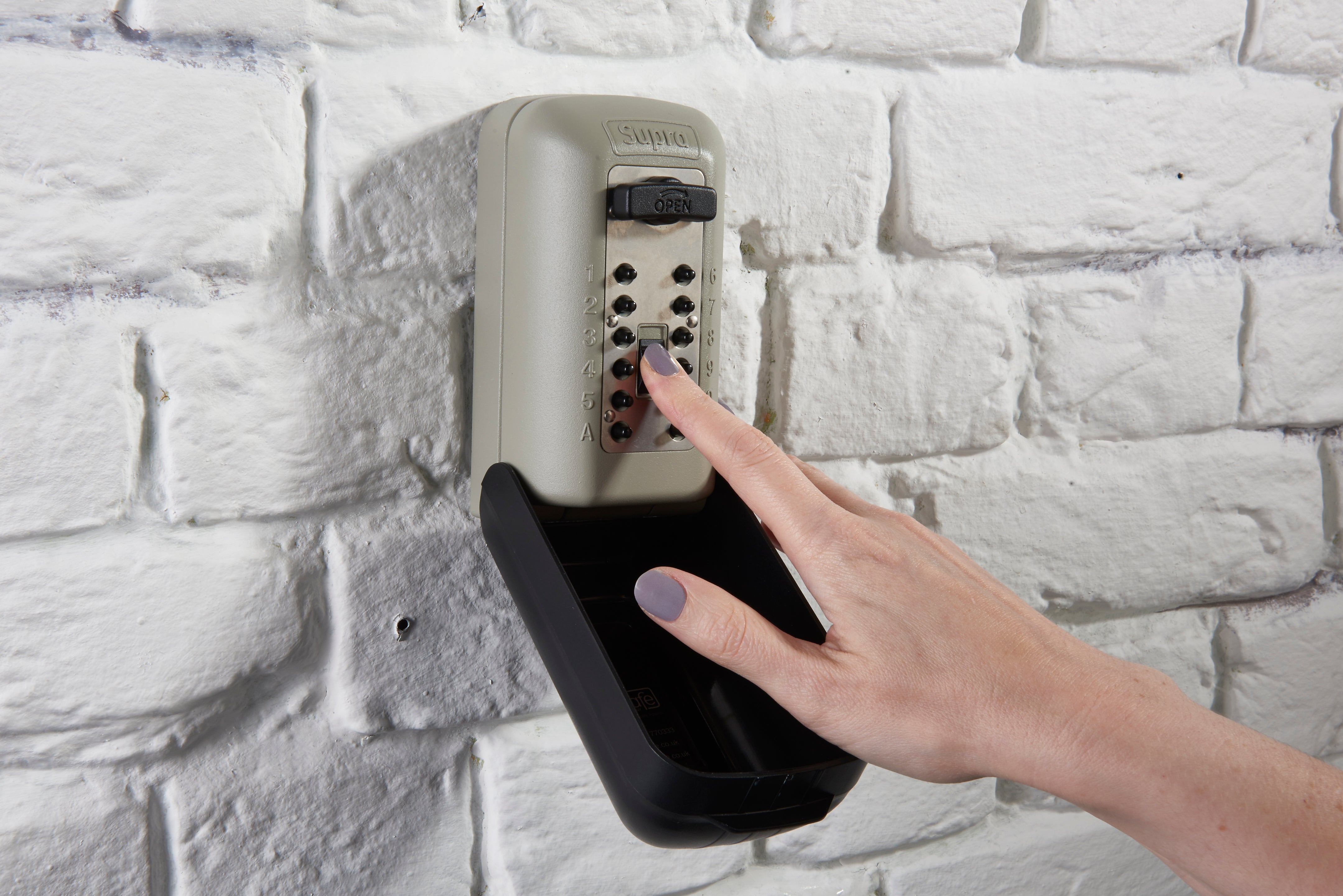 Person putting their key in key safe safely