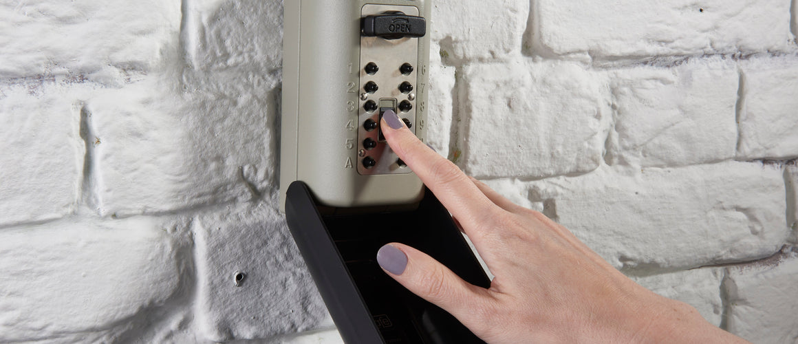 Person putting their key in key safe safely