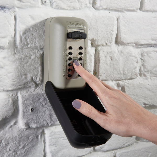 Person putting their key in key safe safely