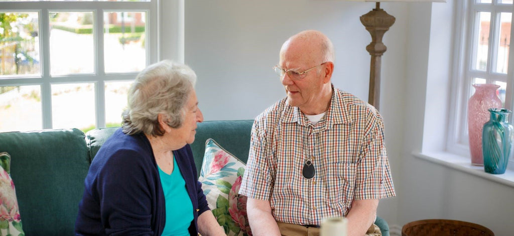 Elderly couple happy and confident with a personal alarm