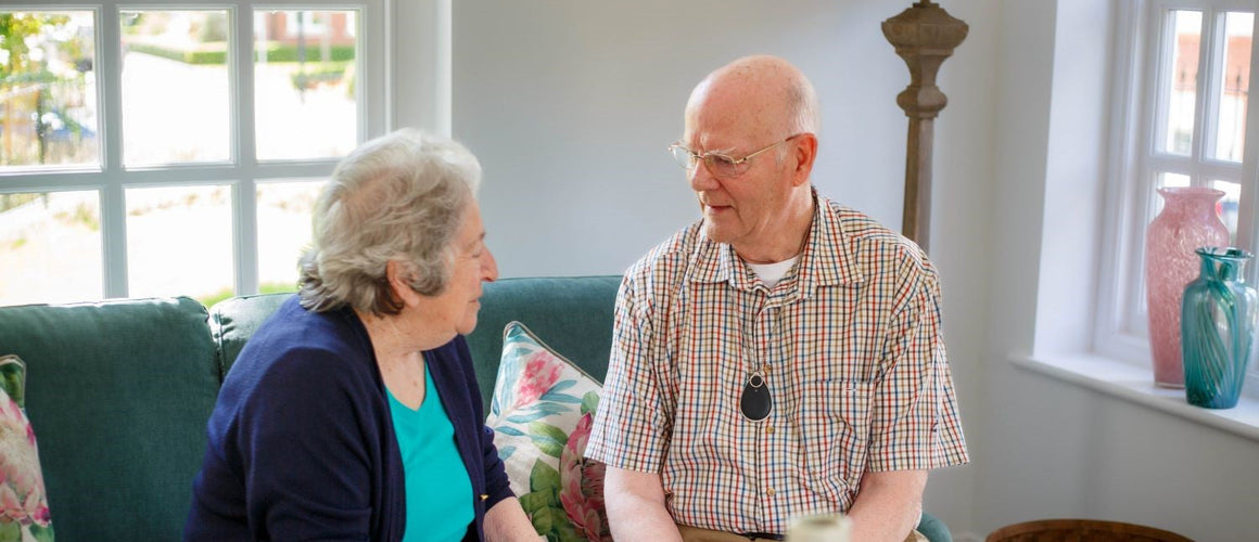 Elderly couple happy and confident with a personal alarm