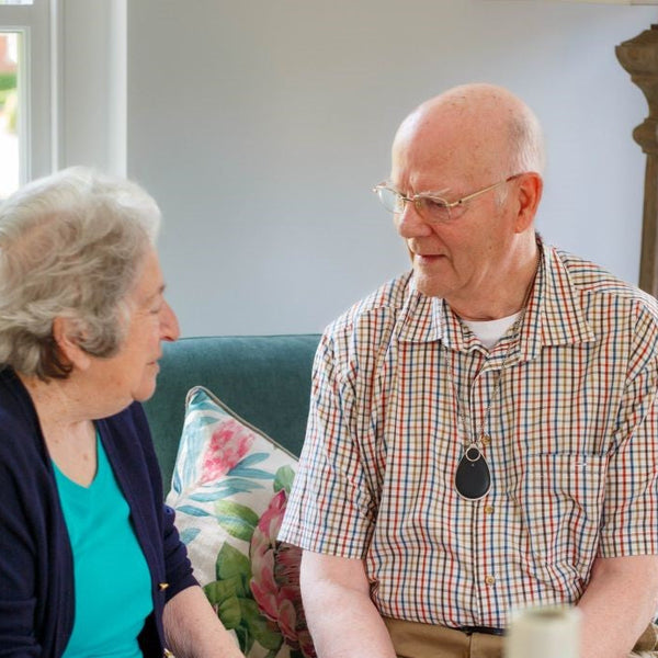 Elderly couple happy and confident with a personal alarm