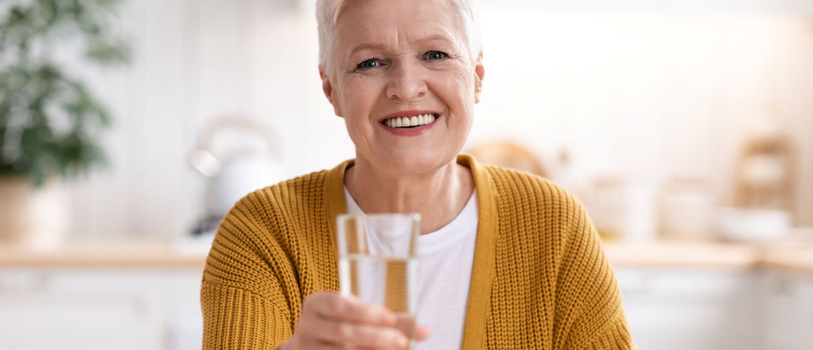Elderly woman holding a glass of water