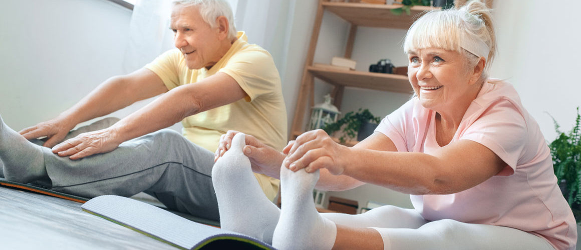 Older man and woman doing yoga exercise at home