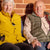 Two older adults sat on a bench