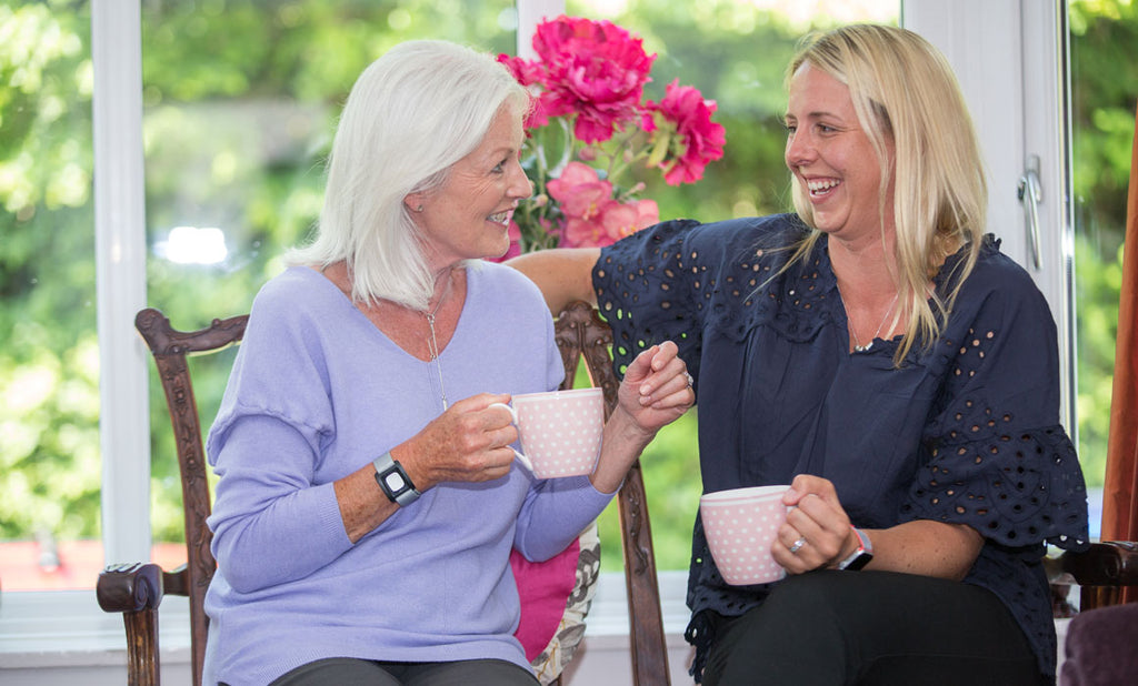 Daughter talking to elderly mother