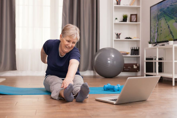 Elderly lady stretching her feet