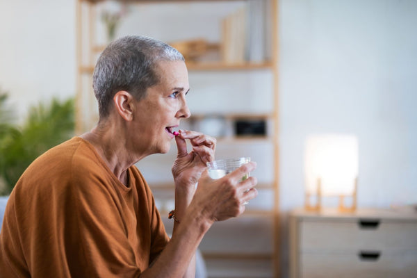 elderly woman taking her medicines