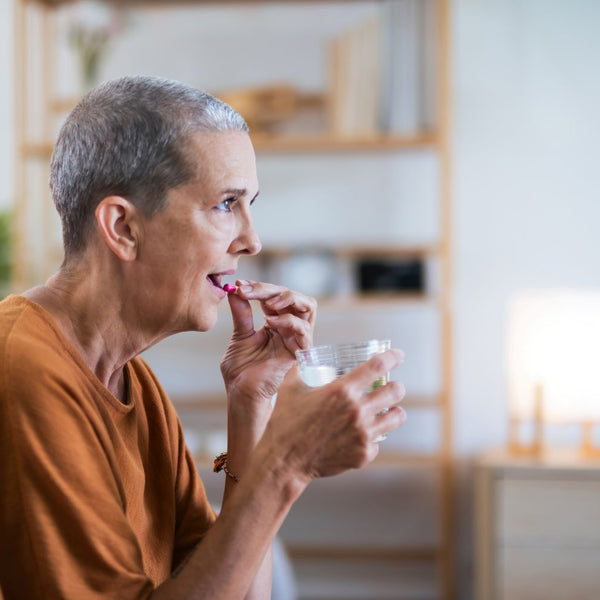 elderly woman taking her medicines