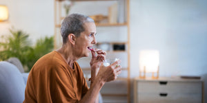 elderly woman taking her medicines
