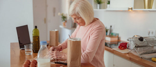 Elderly person cooking a meal