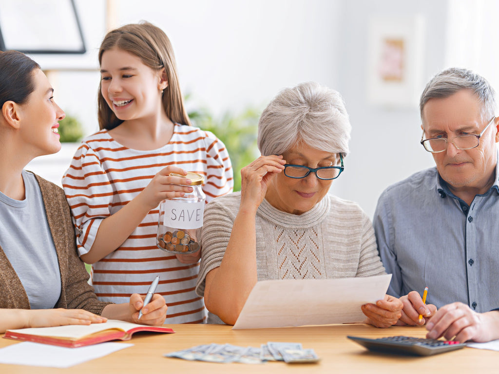 Happy family helping elderly manage budget