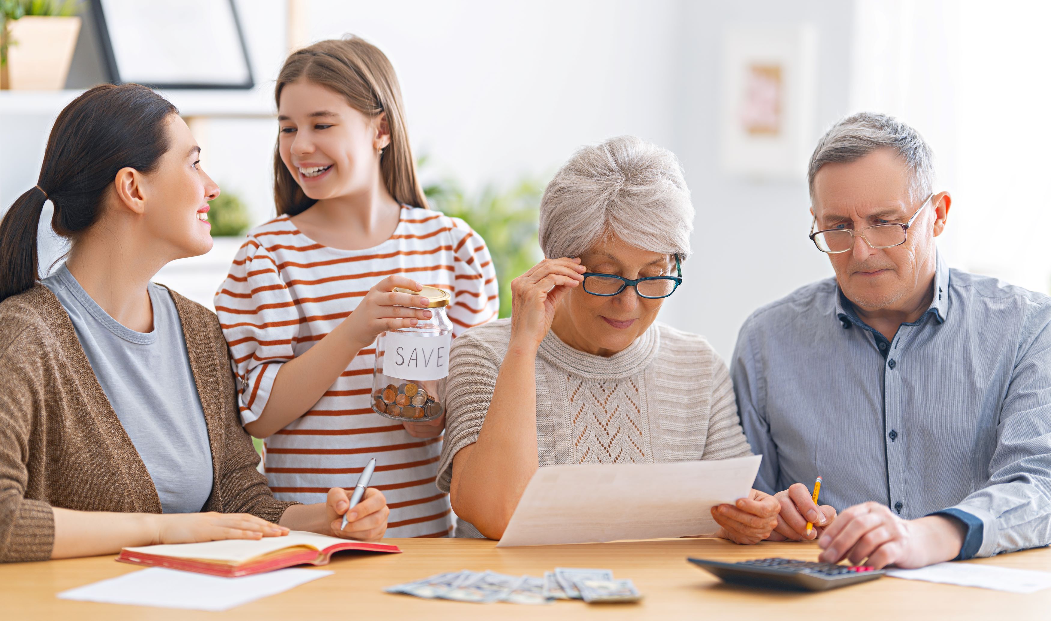 Happy family helping elderly manage budget