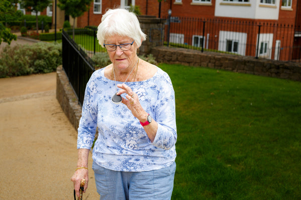 An elderly woman with her GPS enabled careline alarm