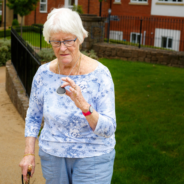 An elderly woman with her GPS enabled careline alarm