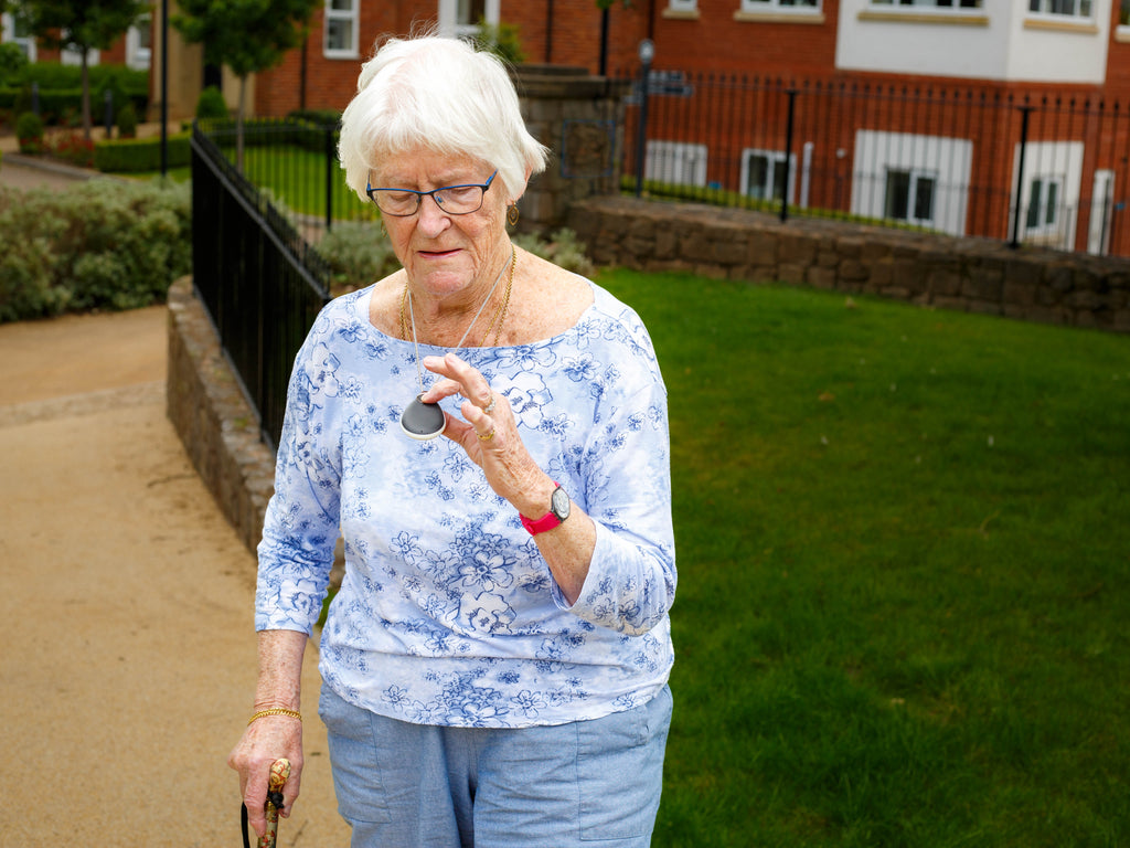 An elderly woman with her GPS enabled careline alarm