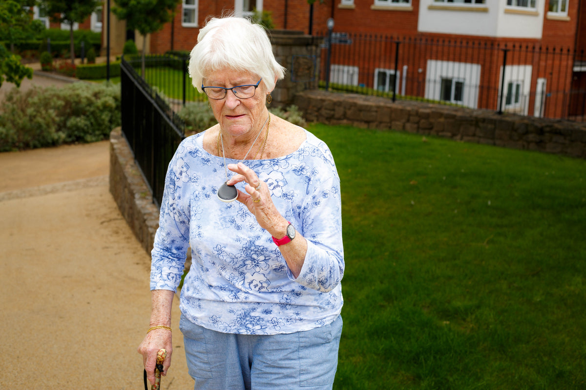 An elderly woman with her GPS enabled careline alarm