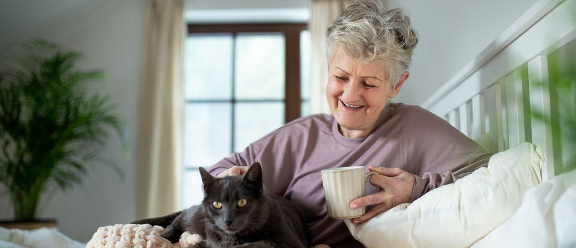 Elderly woman with her cat at home