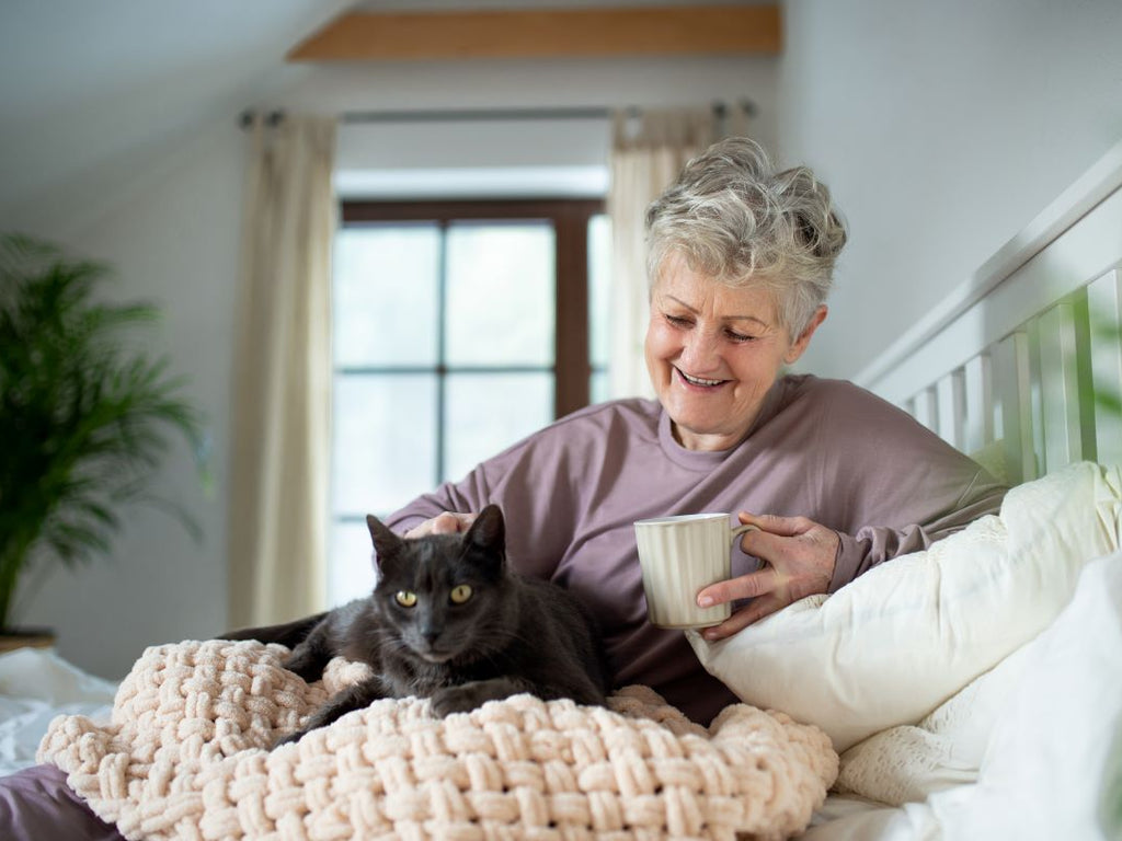 Elderly woman with her cat at home