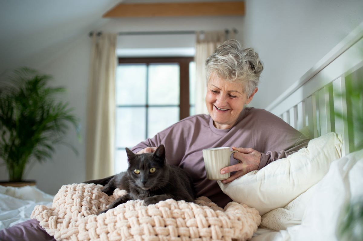 Elderly woman with her cat at home