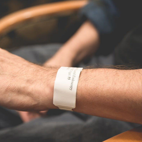 Elderly with a medical bracelet with her medical information on it