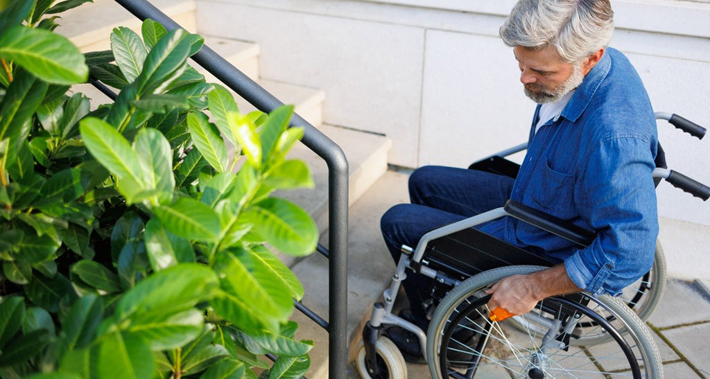 Disabled man by outdoor steps