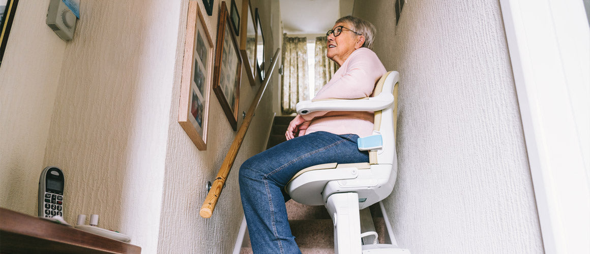 Elderly lady on stairlift