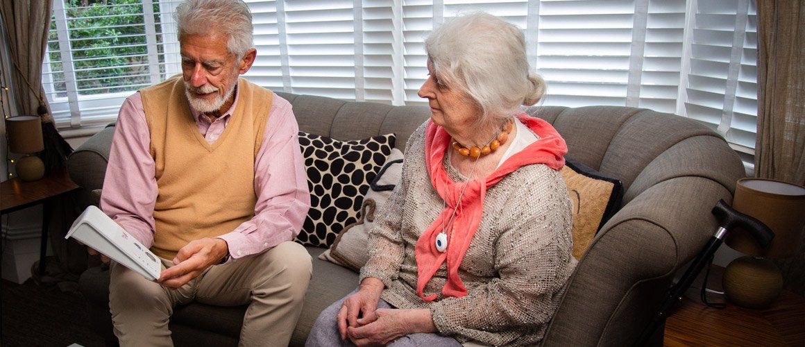 Older couple discussing a shared personal alarm