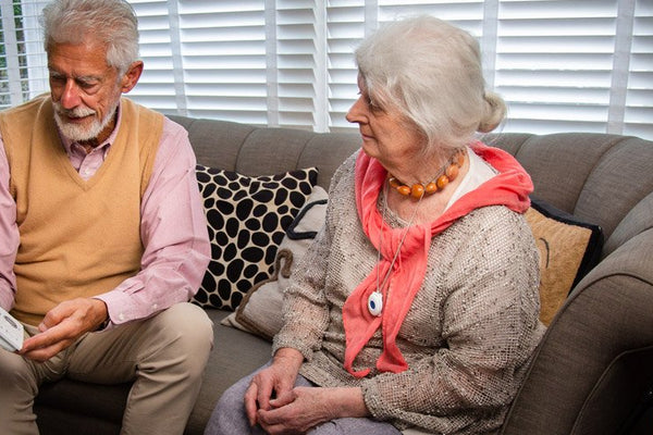 Older couple discussing a shared personal alarm