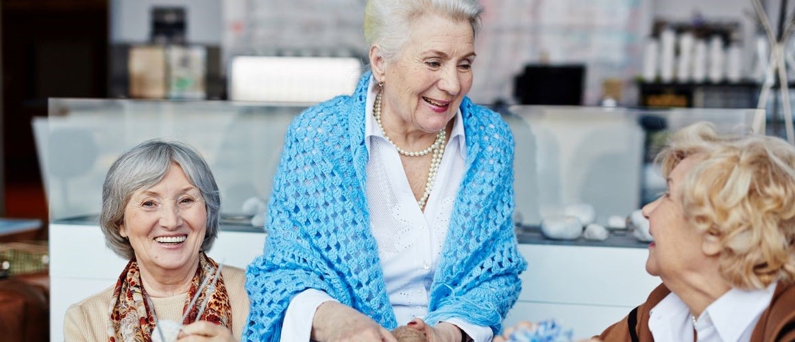 Elderly women knitting together