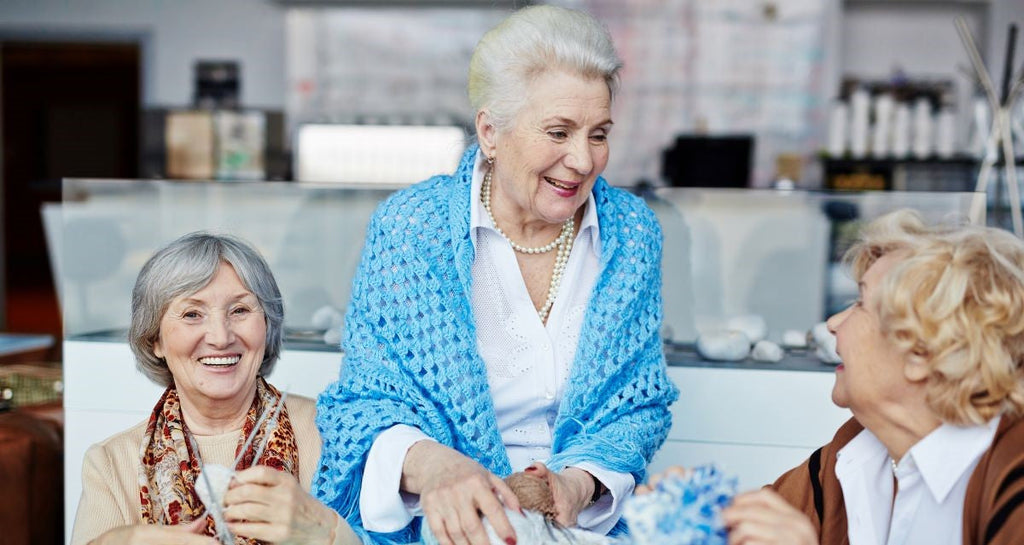 Elderly women knitting together
