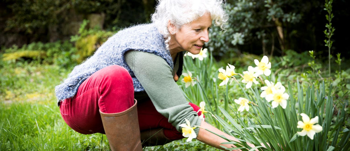 Elderly woman preparing her garden for spring