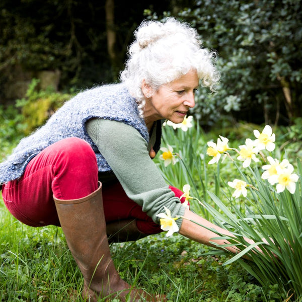 Elderly woman preparing her garden for spring
