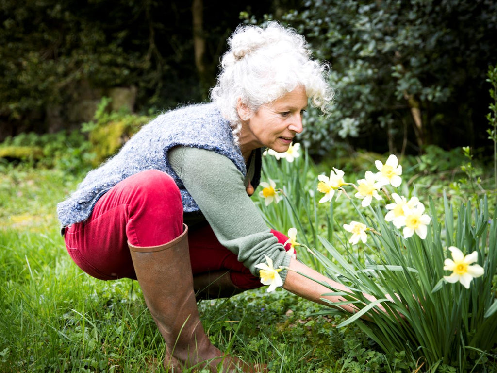 Elderly woman preparing her garden for spring
